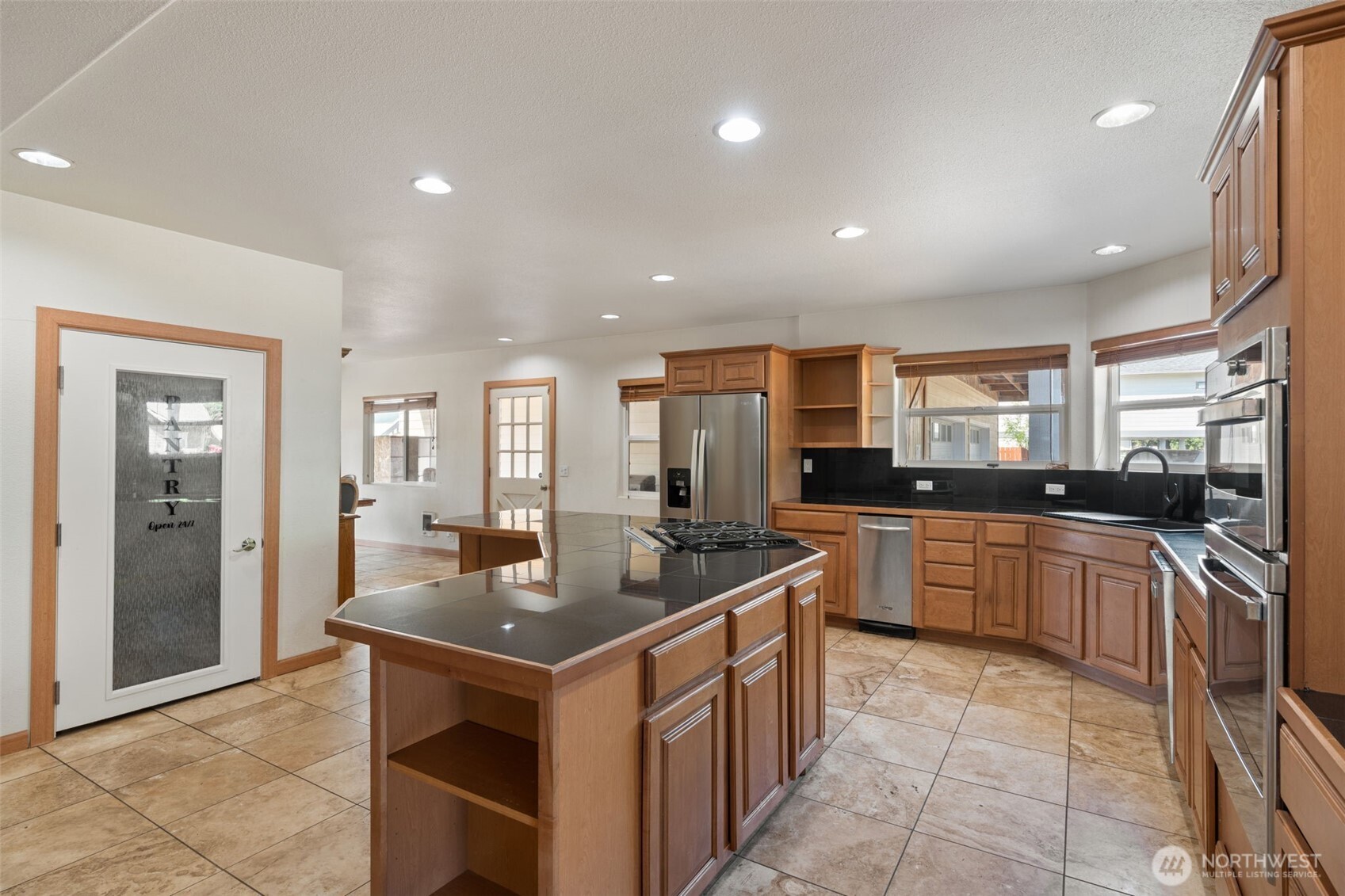 802 State Street Centralia, WA 98531 - Photo 14 of 40 a kitchen with stainless steel appliances granite countertop a sink and a refrigerator