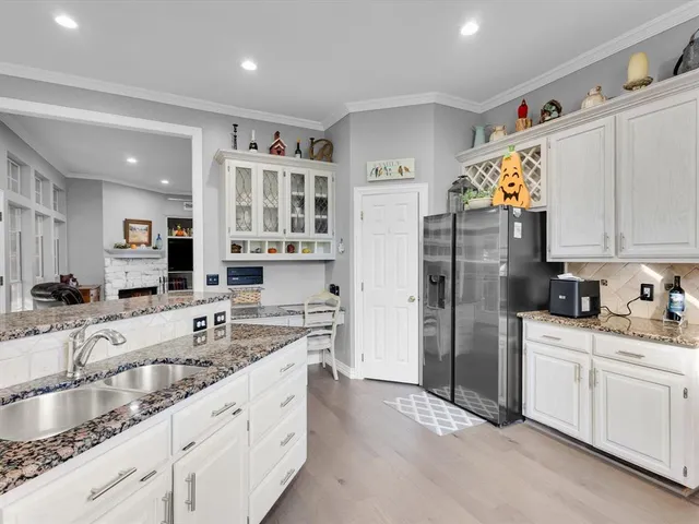 a kitchen with granite countertop a sink cabinets and window