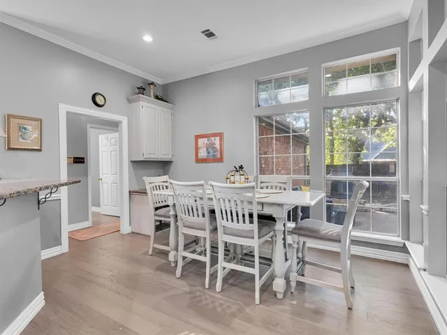 a kitchen with granite countertop a sink stainless steel appliances and cabinets