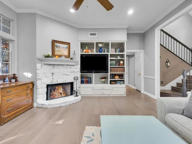 a living room with furniture a fireplace and a flat screen tv