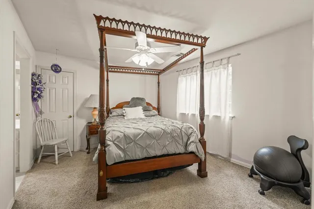a spacious bedroom with a bed and a chandelier
