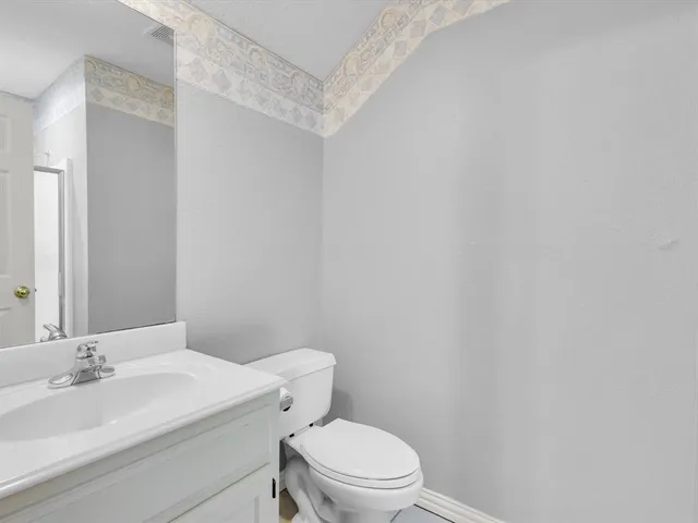 a white toilet sitting next to a bathroom sink