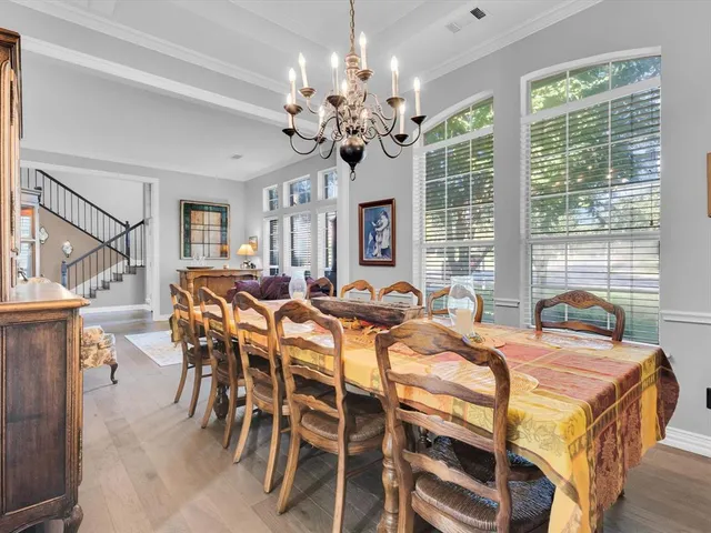 a view of a dining room with furniture wooden floor and chandelier