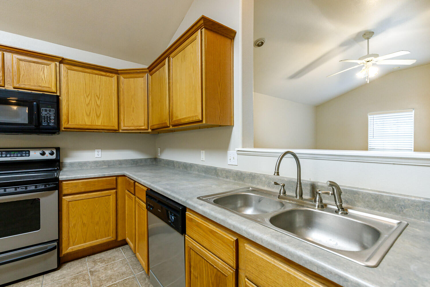 6520 92nd Street Lubbock, TX 79424 - Photo 13 of 30 a kitchen with stainless steel appliances granite countertop a sink stove and microwave