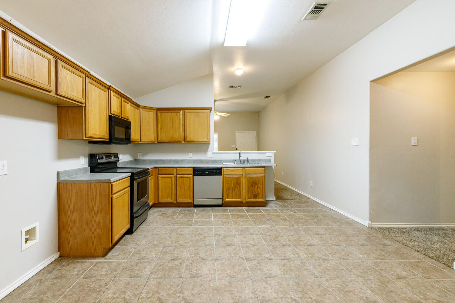 6520 92nd Street Lubbock, TX 79424 - Photo 16 of 30 a large kitchen with stainless steel appliances granite countertop a stove a sink dishwasher and a refrigerator