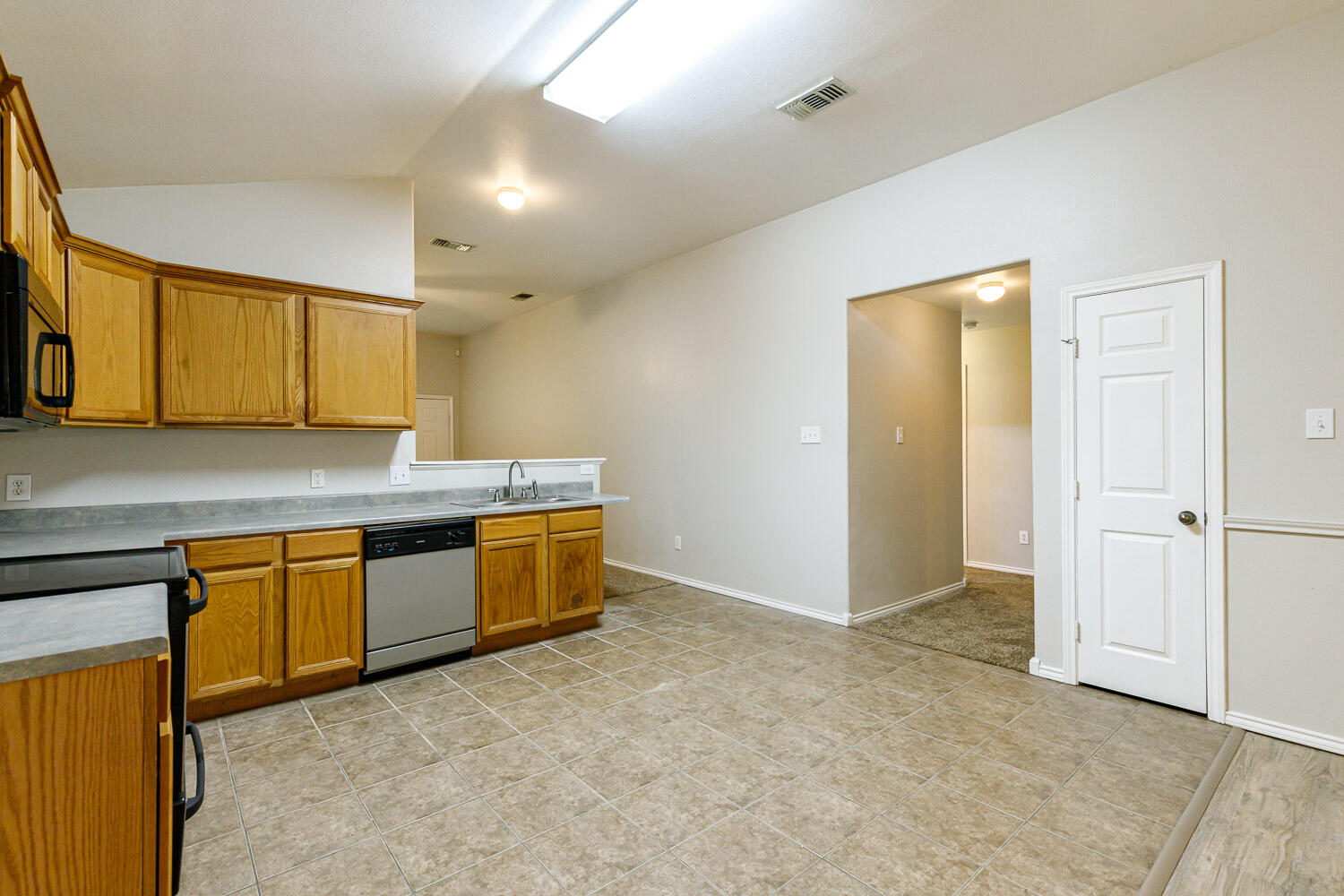 6520 92nd Street Lubbock, TX 79424 - Photo 17 of 30 a kitchen with granite countertop a sink and cabinets