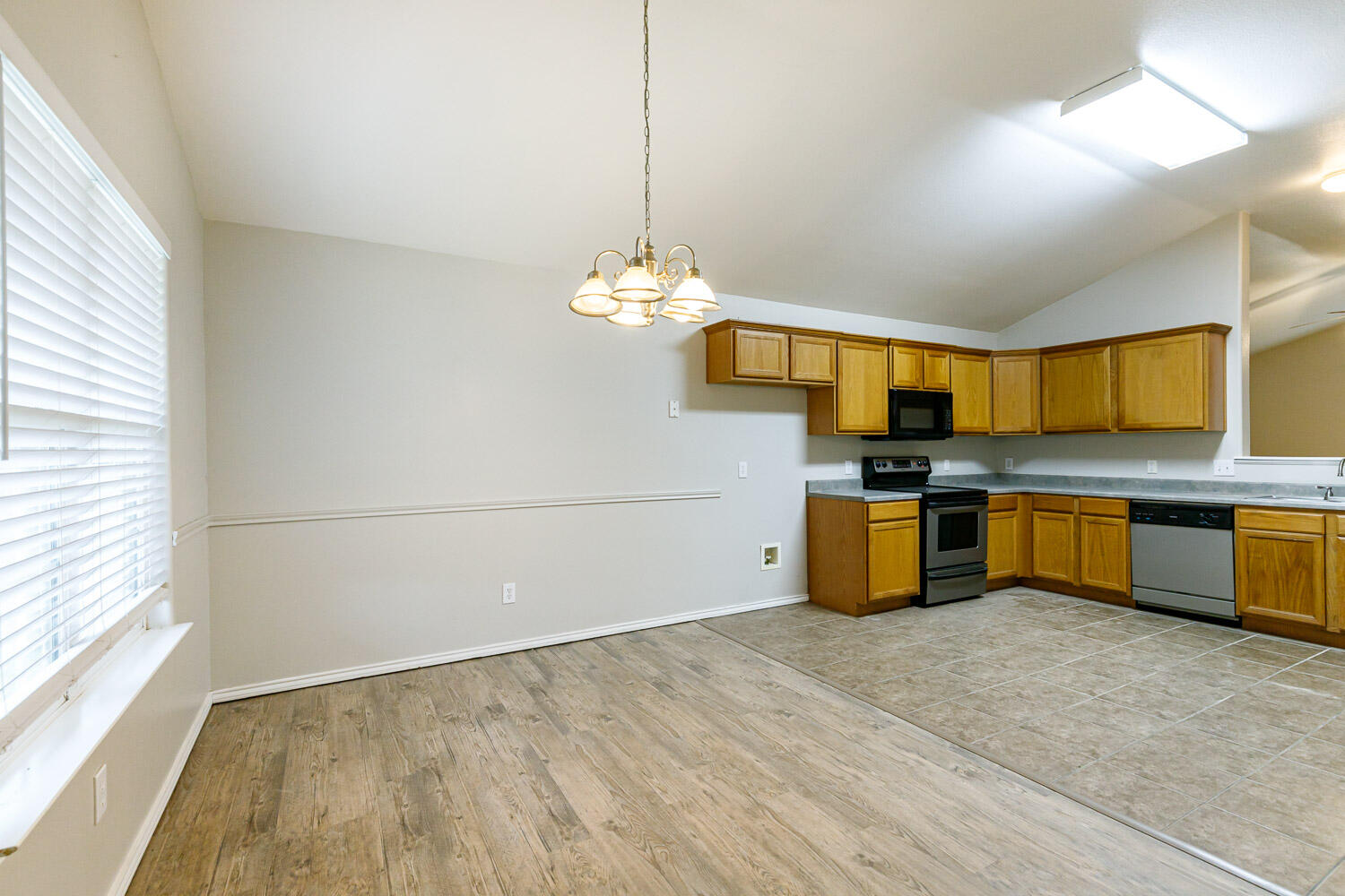 6520 92nd Street Lubbock, TX 79424 - Photo 19 of 30 a kitchen with stainless steel appliances granite countertop a sink a stove top oven a counter space and cabinets