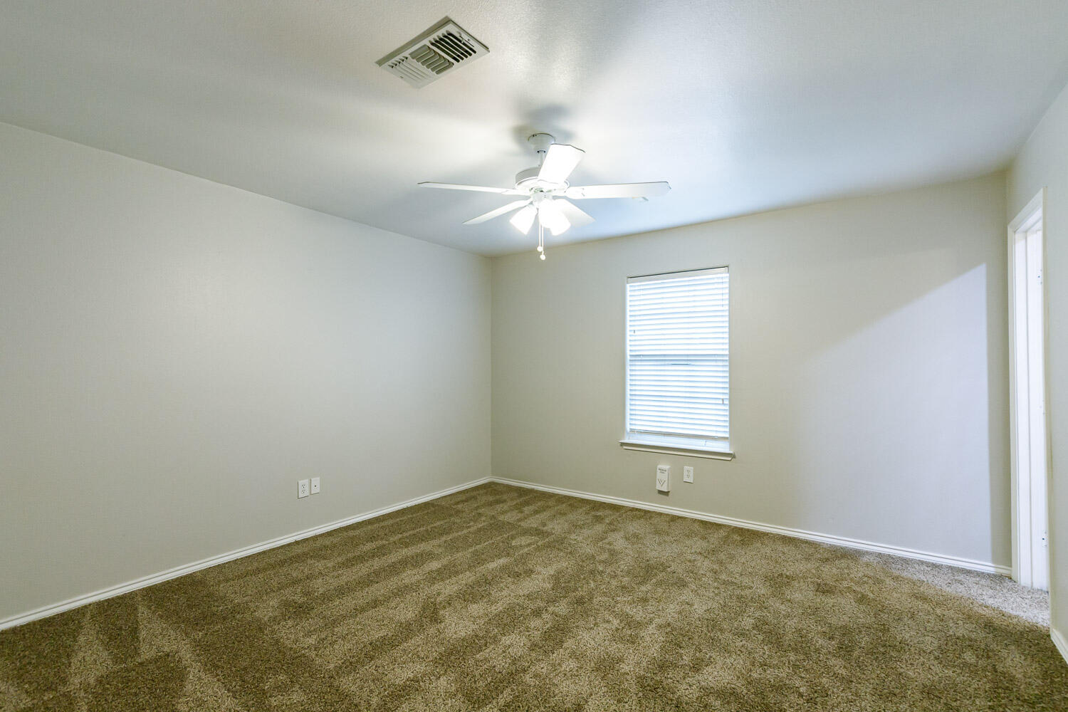 6520 92nd Street Lubbock, TX 79424 - Photo 23 of 30 an empty room with a window and a ceiling fan