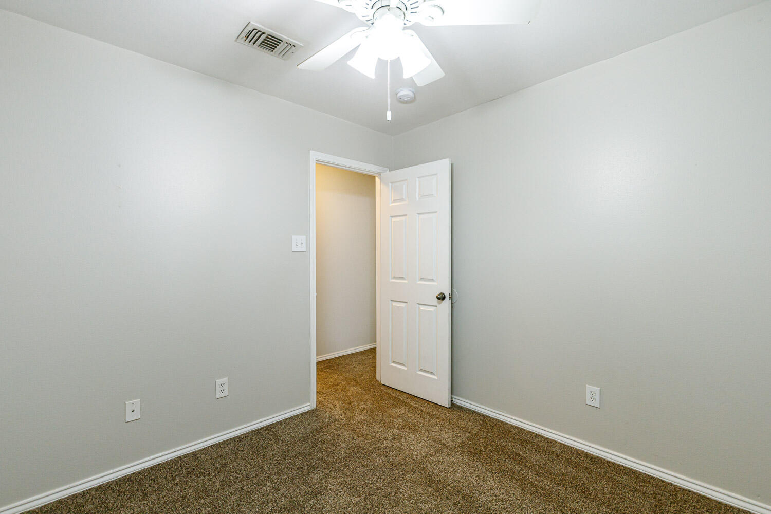 6520 92nd Street Lubbock, TX 79424 - Photo 26 of 30 an empty room with a chandelier fan and closet