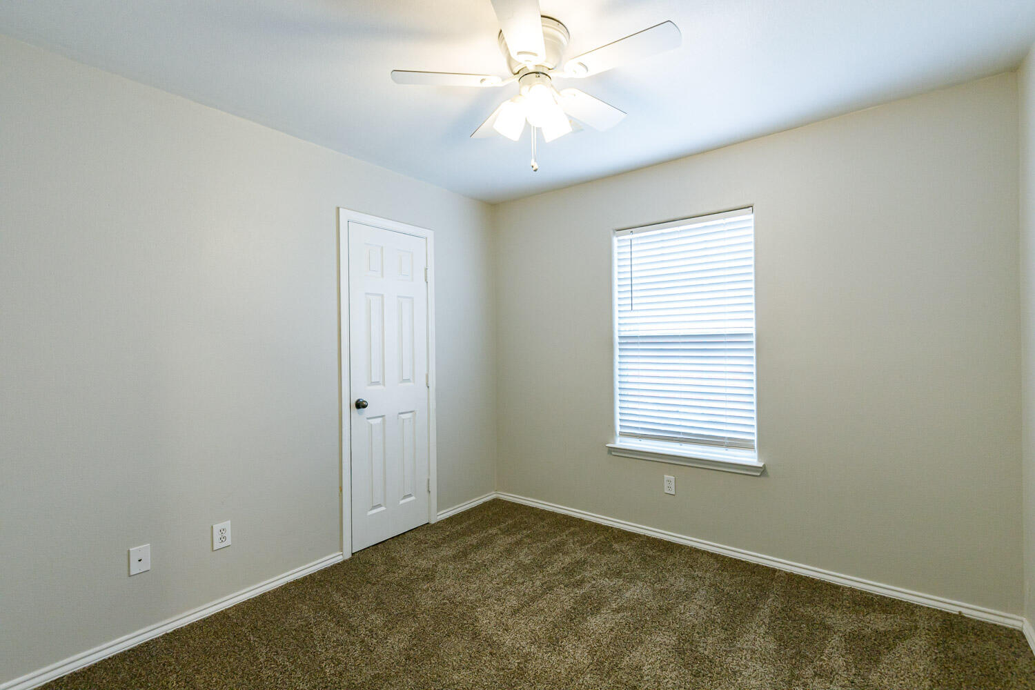 6520 92nd Street Lubbock, TX 79424 - Photo 29 of 30 an empty room with windows and fan
