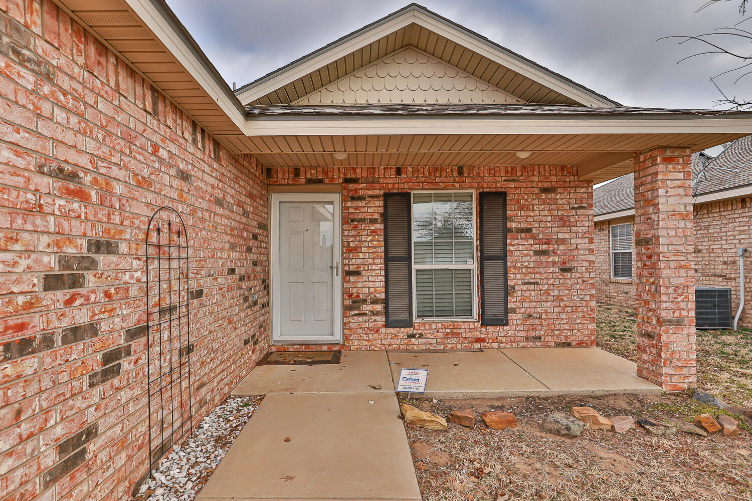 6520 92nd Street Lubbock, TX 79424 - Photo 3 of 30 a front view of a house with a yard