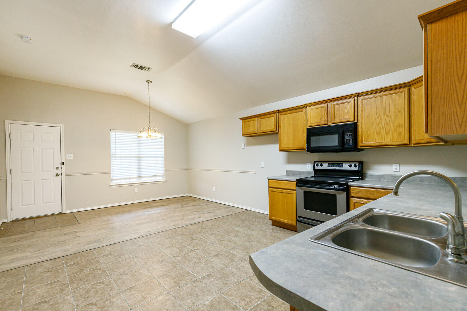 6520 92nd Street Lubbock, TX 79424 - Photo 10 of 30 a kitchen that has a sink and a stove top oven