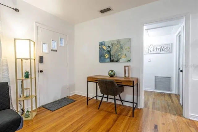 a workspace with furniture and wooden floor