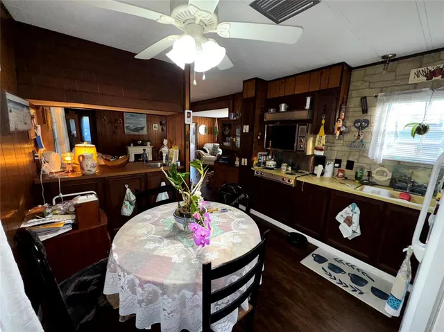 a kitchen with a dining table and chairs