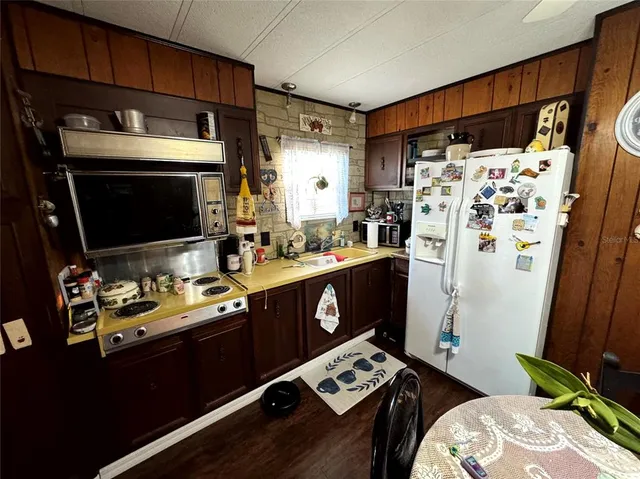 a kitchen with stainless steel appliances a stove a sink and a refrigerator