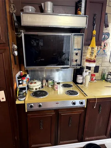a kitchen with a sink a stove and cabinets