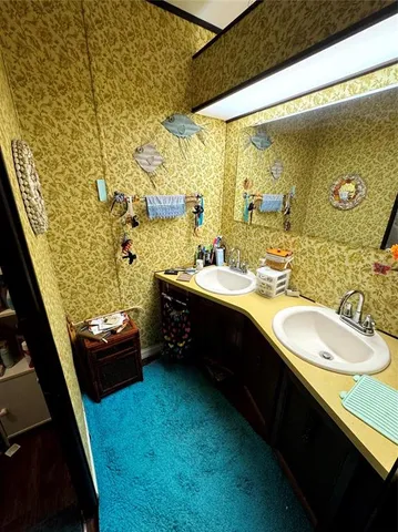 a bathroom with a sink double vanity and a mirror