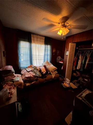 a bedroom with bed and a chandelier