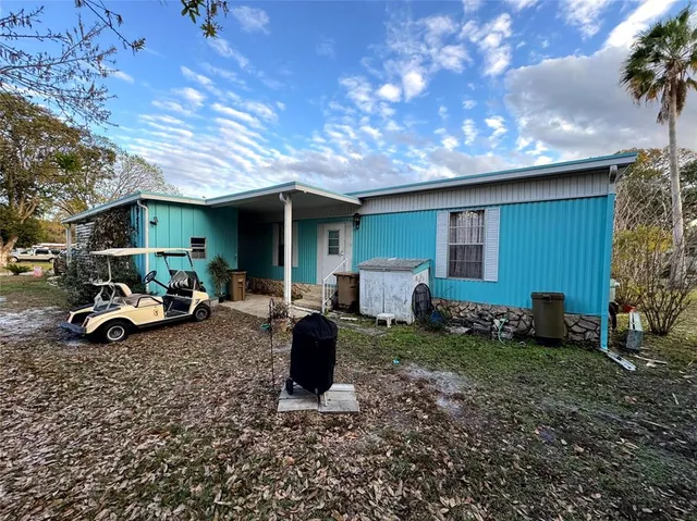 a view of an house with backyard space and sitting area