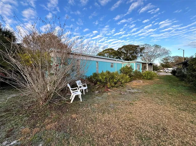 a backyard of a house with table and chairs