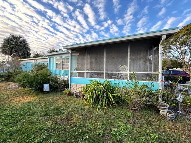a backyard of a house with a garden and plants