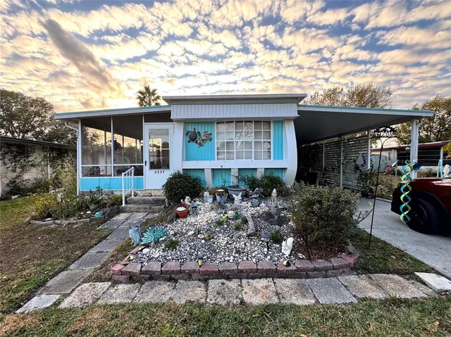 a front view of house with a garden
