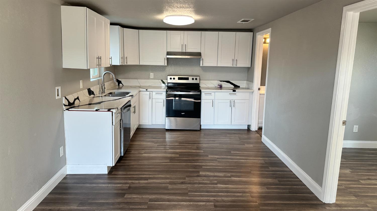 749 East Pleasant Street Coalinga, CA 93210 - Photo 4 of 16 a kitchen with a sink and a stove top oven