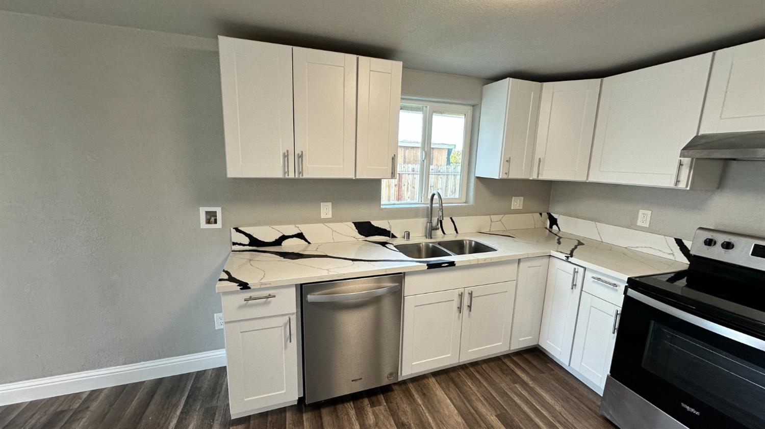 749 East Pleasant Street Coalinga, CA 93210 - Photo 5 of 16 a kitchen with a sink stove and cabinets