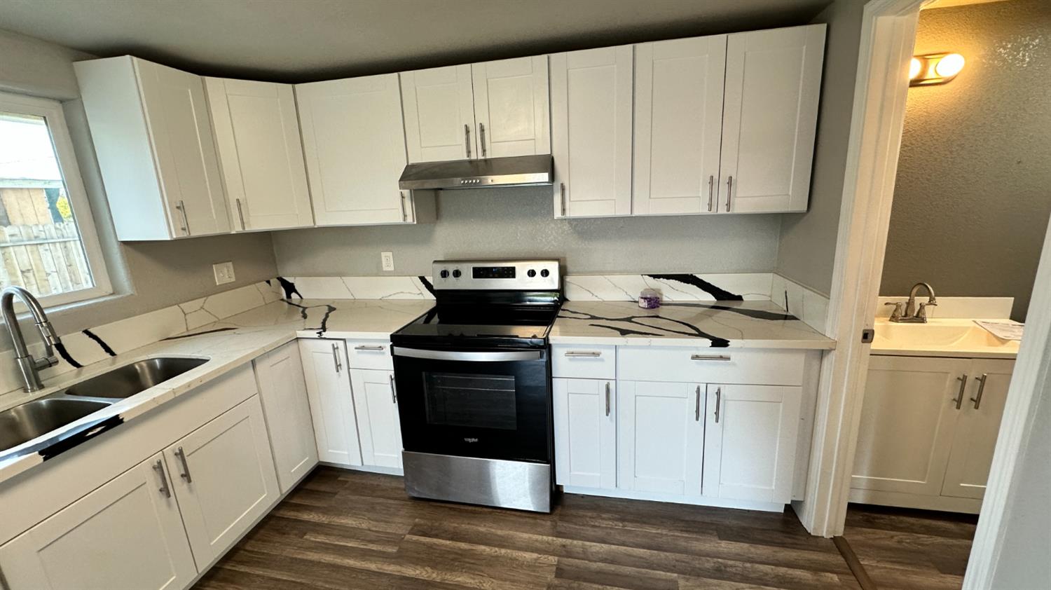 749 East Pleasant Street Coalinga, CA 93210 - Photo 6 of 16 a kitchen with a sink and cabinets