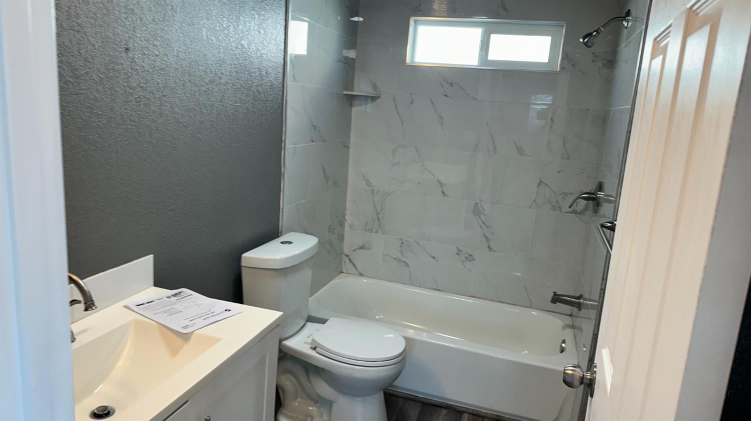 749 East Pleasant Street Coalinga, CA 93210 - Photo 7 of 16 a white toilet sitting next to a bath tub