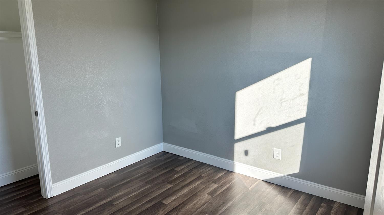 749 East Pleasant Street Coalinga, CA 93210 - Photo 9 of 16 a view of an empty room with wooden floor and a window