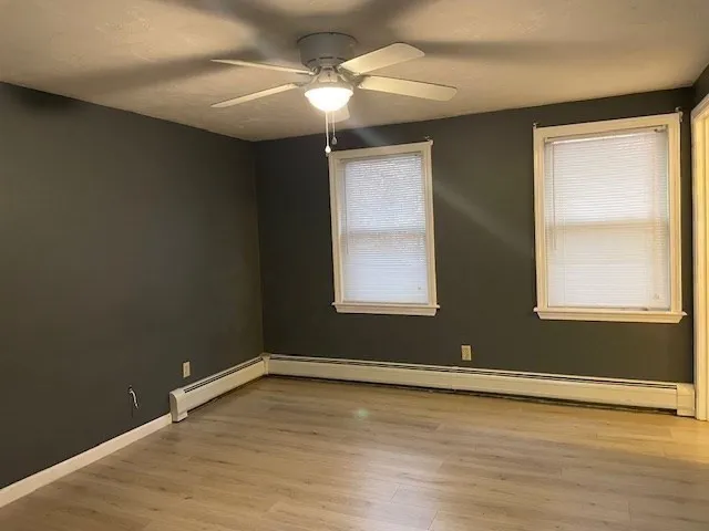wooden floor in an empty room with a window