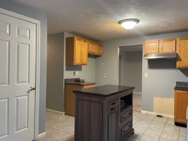 a kitchen that has a sink and a stove in it