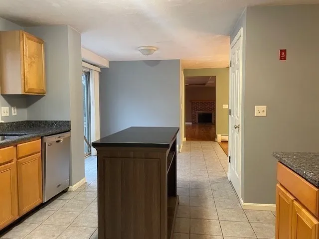 a hallway with cabinets and a wooden floor