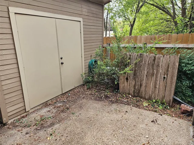 a view of backyard with wooden fence