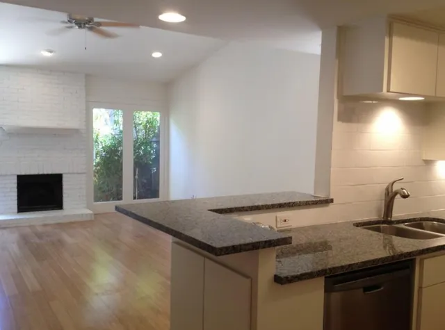 a kitchen with a sink a counter space and a window