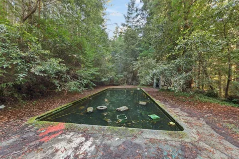 a view of a back yard with swimming pool