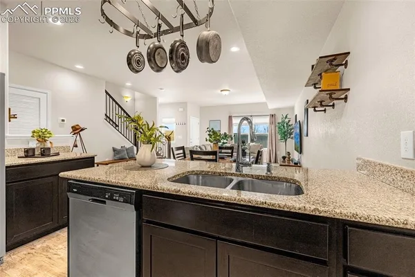 a kitchen with a sink a counter space and stainless steel appliances