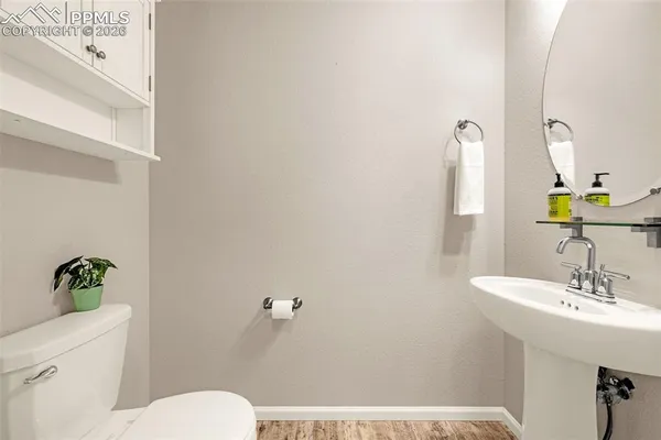 a bathroom with a sink a toilet and a mirror