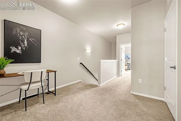 a view of a hallway with seating area
