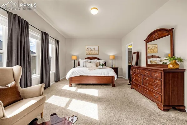 a bedroom with a bed and glass window