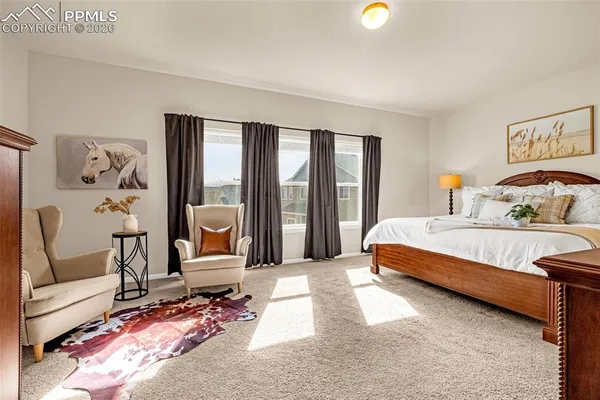 a spacious bedroom with a bed and a large mirror