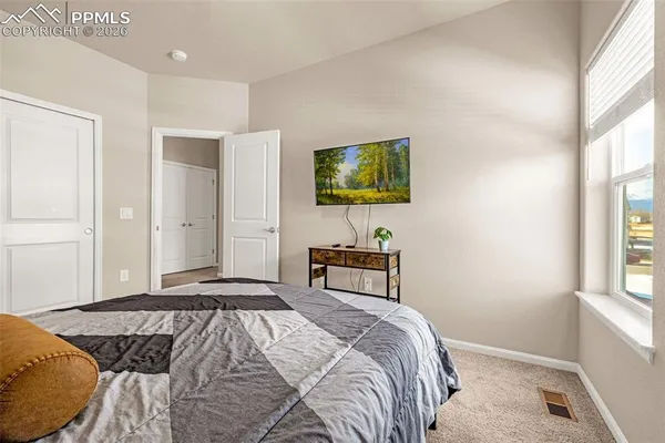 a bedroom with a bed and a window