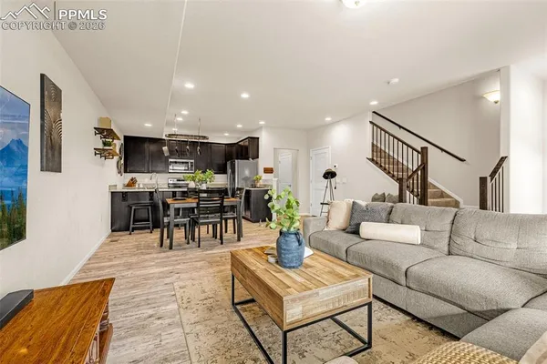 a living room with furniture and kitchen view