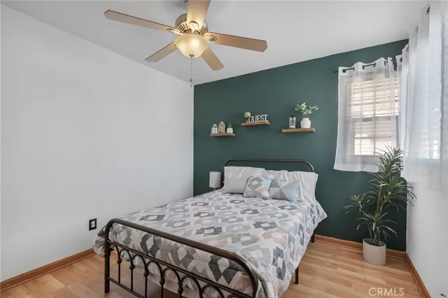 a bedroom with a bed and a potted plant