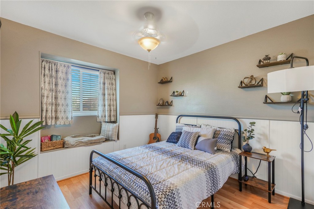 3670 Windstorm Way Riverside, CA 92503 - Photo 16 of 43 a bedroom with a bed and wooden floor