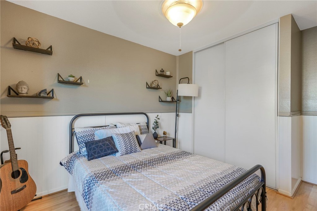 3670 Windstorm Way Riverside, CA 92503 - Photo 17 of 43 a bedroom with a bed and a chandelier