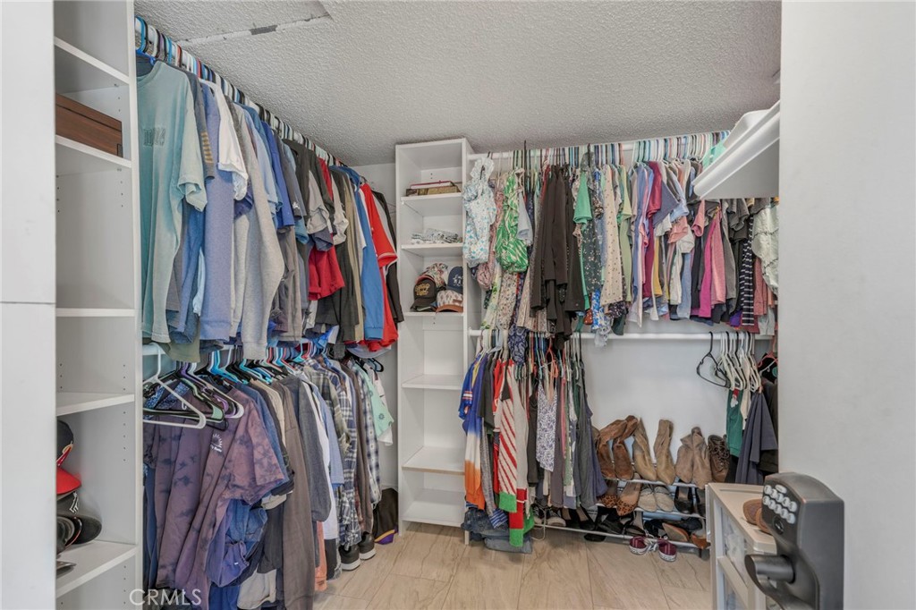 3670 Windstorm Way Riverside, CA 92503 - Photo 23 of 43 a view of walk in closet with clothes