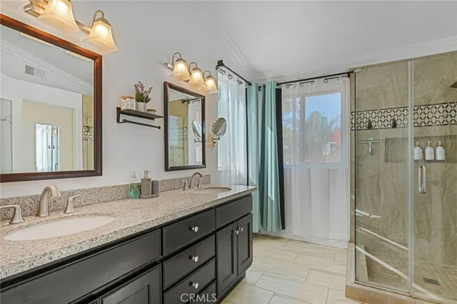 a bathroom with a granite countertop sink mirror and double