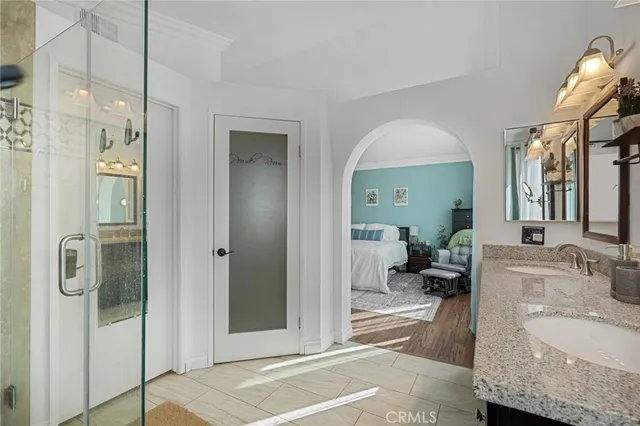 a bathroom with a granite countertop sink mirror and shower